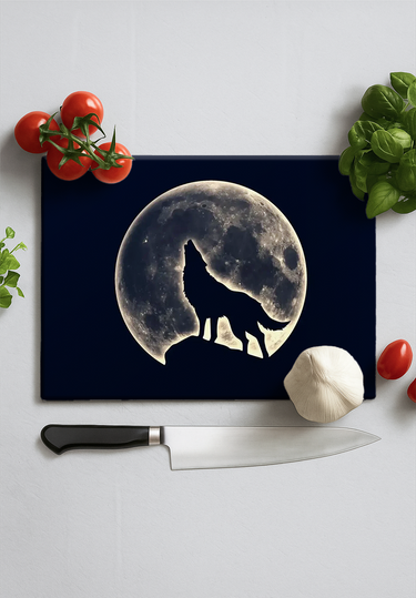 Kitchen chopping board with wolf silhouette howling at full moon design, surrounded by tomatoes, garlic, basil, and knife