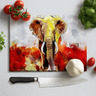 Colorful elephant design chopping board with knife, tomatoes, garlic, and basil on white surface