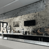 Bespoke speckled glass backsplash in modern kitchen with sleek black cabinets and LED lighting