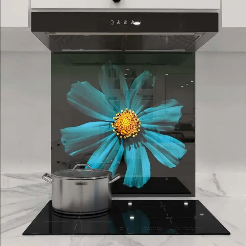 Bespoke kitchen glass splashback with vibrant blue flower design, modern induction hob and extractor hood