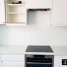 Modern kitchen with sleek white cabinets, built-in oven, and minimalist countertop design