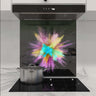 Vibrant powder explosion on custom glass splashback in modern kitchen, showcasing decorative glass design
