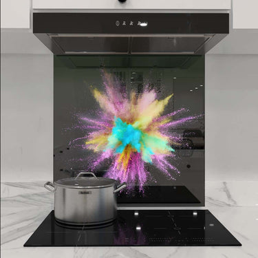 Vibrant powder explosion on custom glass splashback in modern kitchen, showcasing decorative glass design