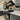 Luxury kitchen with grey cabinets, black range cooker, and decorative glass splashback