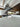Modern kitchen with sleek glass backsplash, marble countertop, and stainless steel range hood