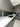 Modern kitchen with sleek gray cabinets, white marble countertop, and integrated appliances