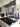 Bespoke speckled glass backsplash in modern kitchen with stainless steel appliances and white cabinetry