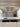 Bespoke kitchen mirror above marble countertop with modern pendant lights and built-in appliances