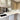 Modern kitchen with sleek glass-front cabinets and integrated appliances for luxury residential design