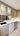 Modern kitchen with sleek glass-front cabinets and integrated appliances for luxury residential design