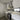 Modern kitchen with sleek white cabinets, glass backsplash, and built-in oven