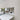 Bespoke feature mirror above modern kitchen sink with skylight, reflecting luxury interior design
