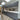 Modern kitchen with grey cabinets, marble backsplash, and skylights for luxury residential design
