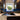 Vibrant underwater scene glass splashback in modern kitchen with dark cabinets and sink