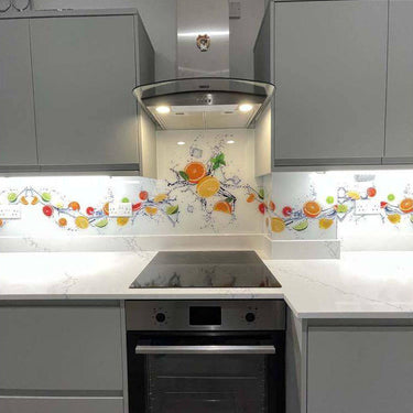Bespoke decorative glass splashback with vibrant fruit design in modern kitchen, featuring LED backlighting