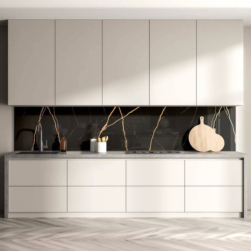 Modern kitchen with black marble-effect glass splashback and sleek white cabinets