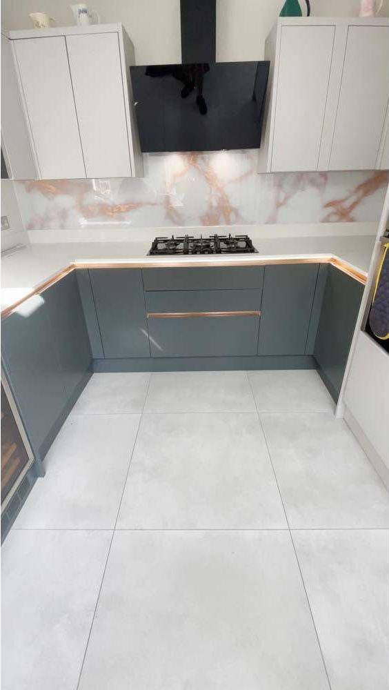 Modern kitchen with marble-effect glass splashback and sleek grey cabinets