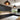 Modern kitchen with bespoke glass splashback, dark cabinets, and pendant lighting