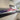 Bespoke decorative glass splashback with flowing red and blue wave design in modern kitchen