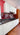 Bespoke red marbled glass kitchen splashback with modern white cabinets and black countertop