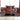 Luxury kitchen with red marble-effect glass splashback, modern white cabinets, and sleek black countertop