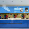 Vibrant rainbow rose printed glass splashback in modern blue kitchen, decorative glass feature