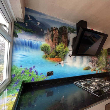 Bespoke decorative glass kitchen backsplash with waterfall landscape mural, modern gas hob and black countertop