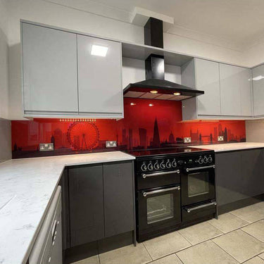 Red London skyline glass backsplash in modern kitchen with black range cooker and grey cabinets