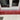 Red gradient glass windowsill in modern kitchen with marble countertop and white window frame