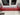 Red gradient glass windowsill in modern kitchen with marble countertop and white window frame