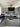 Modern kitchen with black marble-effect glass splashback and grey cabinets
