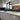 Bespoke decorative glass kitchen splashback with ocean sunset design, modern white cabinets, marble countertop