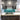 Modern kitchen with teal glass backsplash, dark wood cabinets, and marble countertop