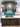Modern kitchen with teal glass backsplash, dark wood cabinets, and marble countertop