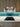 Turquoise gradient glass kitchen splashback with LED lighting, modern wood cabinets and gas hob