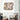 Abstract face artwork on wall above modern armchair in stylish living room