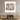 Abstract face art print on wall above wooden media console in modern living room