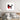 Abstract red black white wall art above modern bed in minimalist bedroom