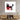 Abstract red black white wall art above modern wooden media console in minimalist living room