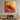 Abstract art print with bold red, orange, and black brushstrokes displayed above modern wooden media console