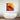 Abstract art glass panel with bold red and gold design above modern bathtub in luxury bathroom