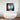 Colorful geometric face art above modern freestanding bathtub in luxury bathroom