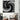 Black and white halftone abstract wall art in modern living room with houndstooth armchair