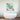 Colorful abstract glass art above modern bathtub, featuring geometric circles and vibrant hues for luxury bathroom decor
