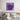 Abstract glass art with swirling red and purple hues, displayed above a modern bed.