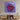 Bespoke decorative glass art with swirling red and purple design, mounted above modern wooden console in luxury interior