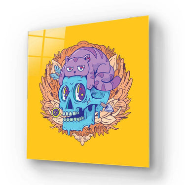 Vibrant glass art panel featuring a purple cat atop a blue skull with wings, set against yellow background