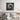 Modern bedroom with abstract black and white wall art above wooden bed frame