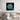 Bespoke decorative glass artwork with blue and yellow abstract design above a modern bed