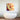 Pop art glass wall art with bold red and yellow design above modern bathtub in luxury bathroom